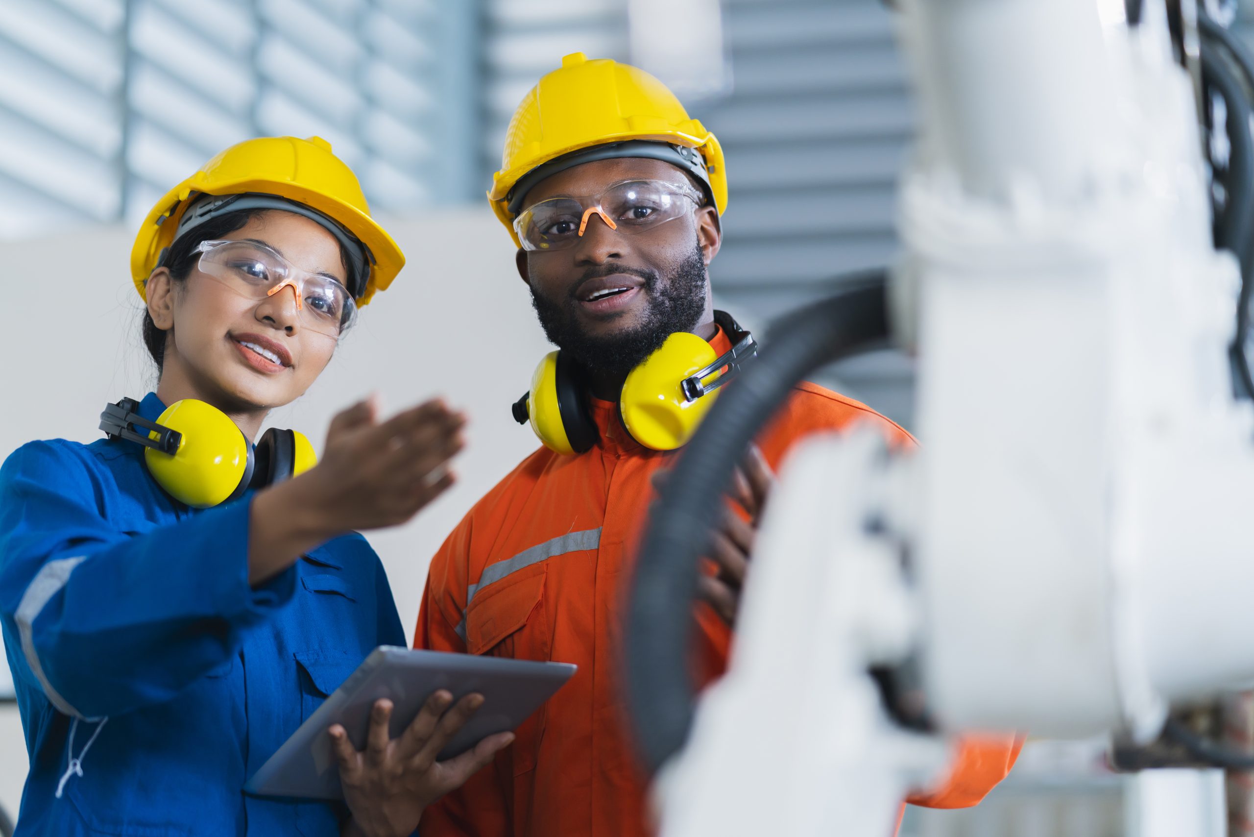 engineer-cooperation-male-female-technician-maintenance-control-relay-robot-arm-system-welding-with-tablet-laptop-control-quality-operate-process-work-heavy-industry-40-manufacturing-factory